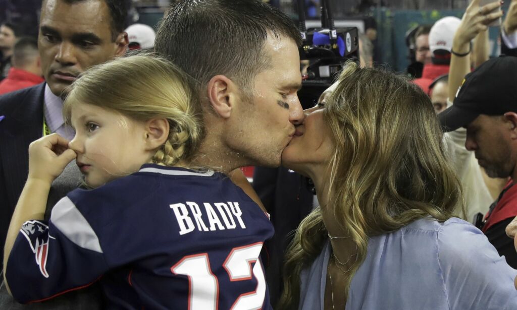 New England Patriots' Tom Brady kisses his wife Gisele Bundchen after his team defeated the Atlanta Falcons in overtime at the NFL Super Bowl 51 football game Sunday, Feb. 5, 2017, in Houston. The Patriots defeated the Falcons 34-28. At left is their daughter, Vivian. (AP Photo/Patrick Semansky)