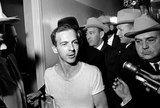 FILE - In this Nov. 23, 1963, file photo, surrounded by detectives, Lee Harvey Oswald talks to the media as he is led down a corridor of the Dallas police station for another round of questioning in connection with the assassination of U.S. President John F. Kennedy. President Donald Trump is caught in a push-pull on new details of KennedyÄôs assassination, jammed between students of the killing who want every scrap of information and intelligence agencies that are said to be counseling restraint. How that plays out should be known on Oct. 26, 2017, when long-secret files are expected to be released. (AP Photo)