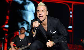 Singer Robbie Williams performs on stage during a concert to celebrate the tenth anniversary of the reign of Albert II, in front of the Monaco Palace in Monaco, Sunday, July 12, 2015. (Jean Pierre Amet/Pool via AP)